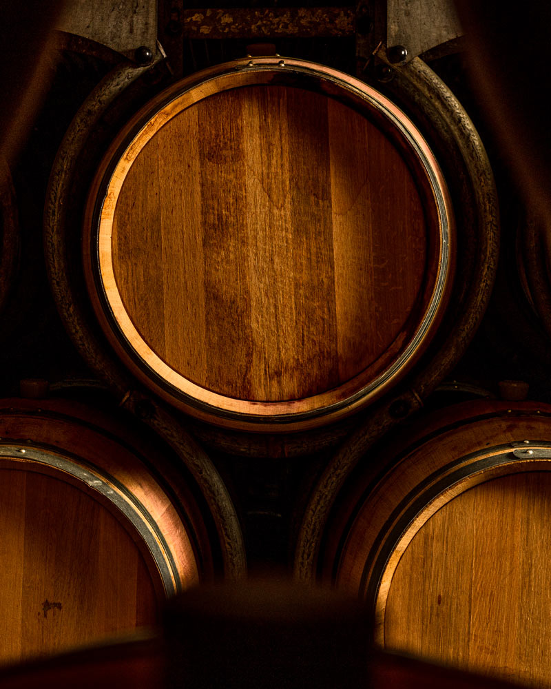 Close-up shot of three French oak barrels, stacked in a triangle, in Grgich Hills Estate's wine cellar.