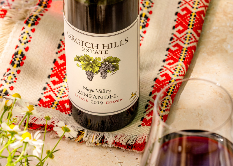A bottle of Napa Valley Zinfandel from Grgich Hills Estate, set atop a piece of traditional Croatian fabric.