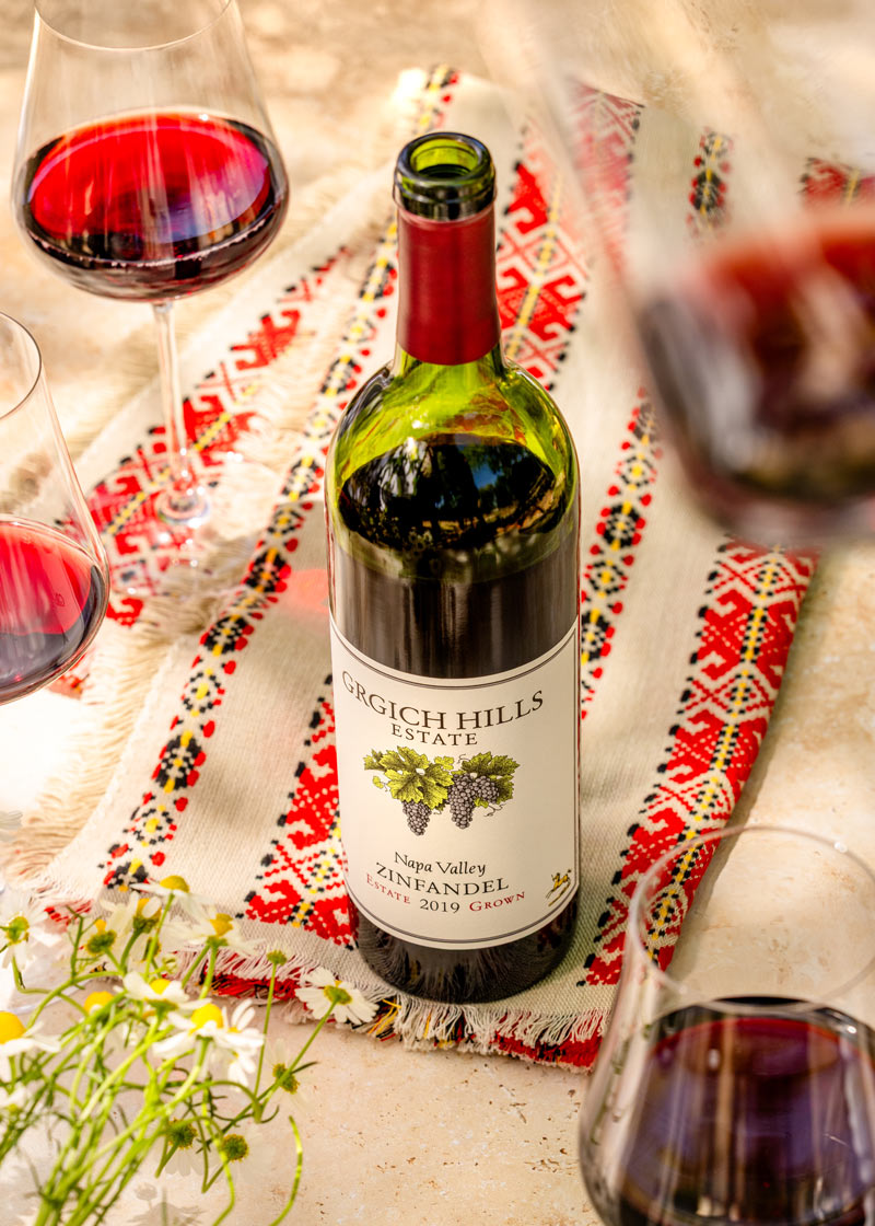 A bottle of Napa Valley Zinfandel from Grgich Hills Estate, set atop a piece of traditional Croatian fabric.