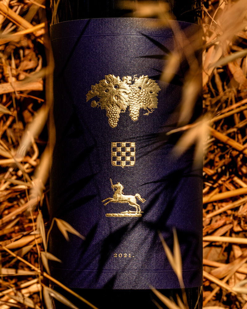 Grgich Hills Estate's 2021 Paradise Block Cabernet Sauvignon, placed delicately on a bed of golden straw.