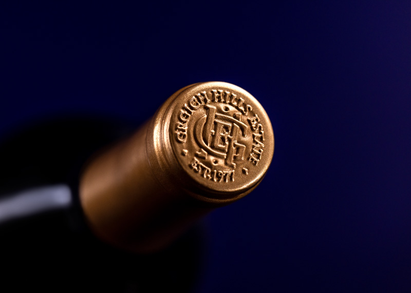 The embossed, golden top of the foil capsule on a bottle of Paradise Block Cabernet Sauvignon. It bears the logo of Grgich Hills Estate, established in Napa Valley in 1977.