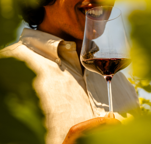 Man Holding a wine glass out in nature